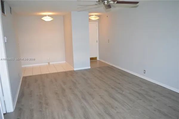 a view of a room with wooden floor