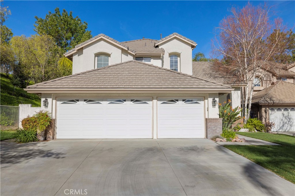 25603 Shaw Place Stevenson Ranch, CA 91381 - Photo 1 of 1 a front view of a house with a yard and garage