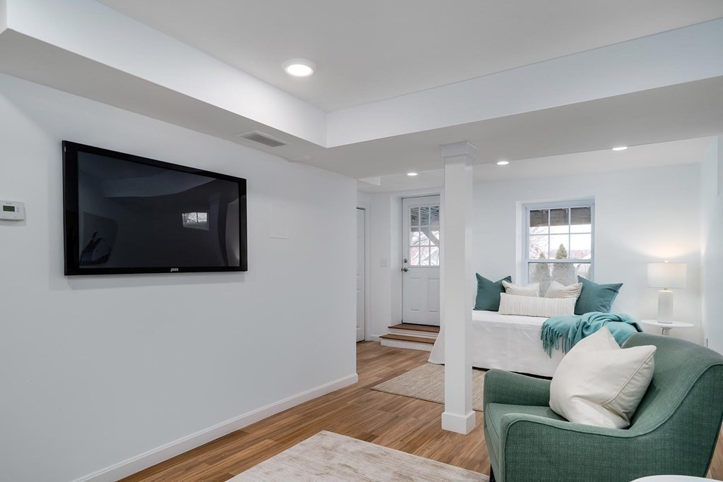 10 Jenness Road Brookline, MA 02446 - Photo 15 of 20 a living room with furniture and a flat screen tv