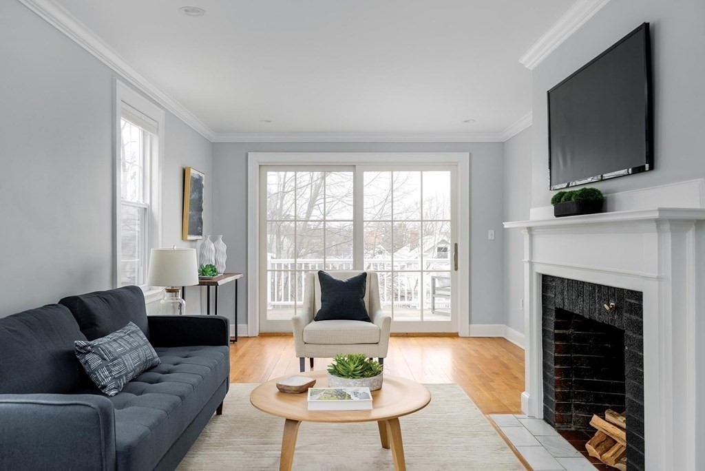 10 Jenness Road Brookline, MA 02446 - Photo 2 of 20 a living room with furniture a flat screen tv and a fireplace