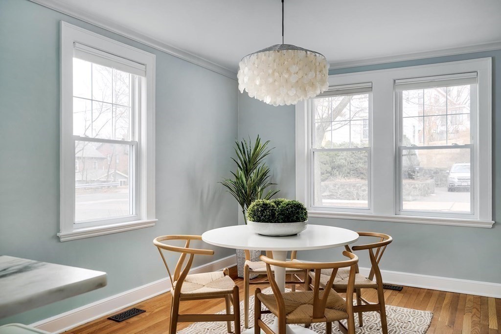 10 Jenness Road Brookline, MA 02446 - Photo 3 of 20 a dining room with furniture a chandelier and wooden floor