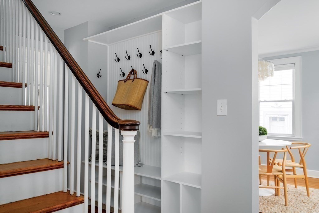 10 Jenness Road Brookline, MA 02446 - Photo 7 of 20 a view of staircase with lots of frames on wall and a window