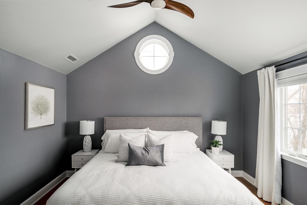 10 Jenness Road Brookline, MA 02446 - Photo 8 of 20 a bedroom with a bed and a chandelier