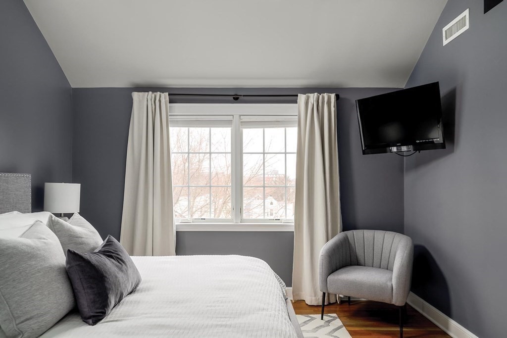 10 Jenness Road Brookline, MA 02446 - Photo 9 of 20 a bedroom with a bed and a television