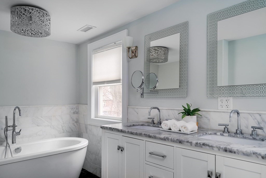 10 Jenness Road Brookline, MA 02446 - Photo 10 of 20 a bathroom with a granite countertop sink and a mirror