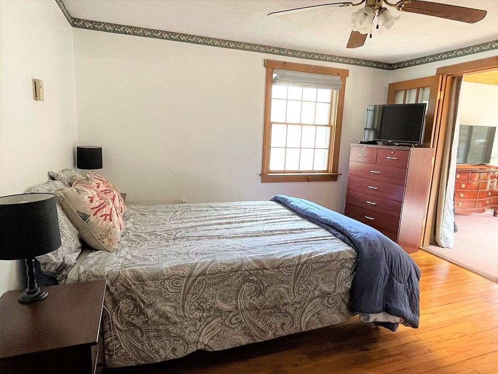 15 Shepard Road Sturbridge, MA 01566 - Photo 11 of 38 a bedroom with a bed and wooden floor