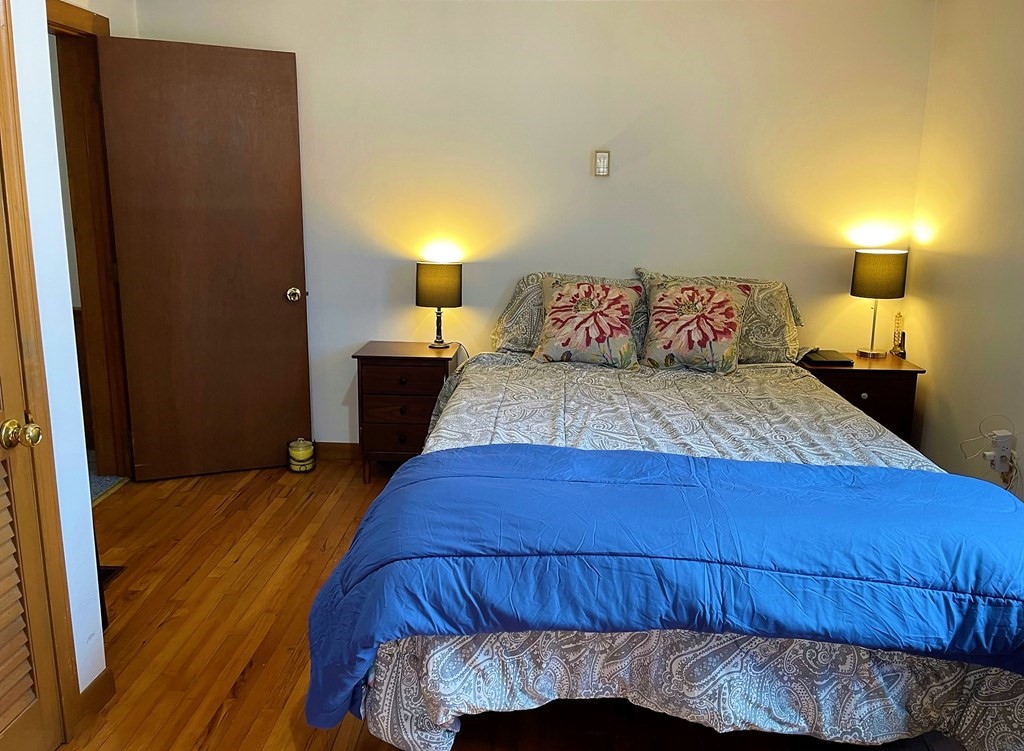 15 Shepard Road Sturbridge, MA 01566 - Photo 12 of 38 a bedroom with a bed and a lamp