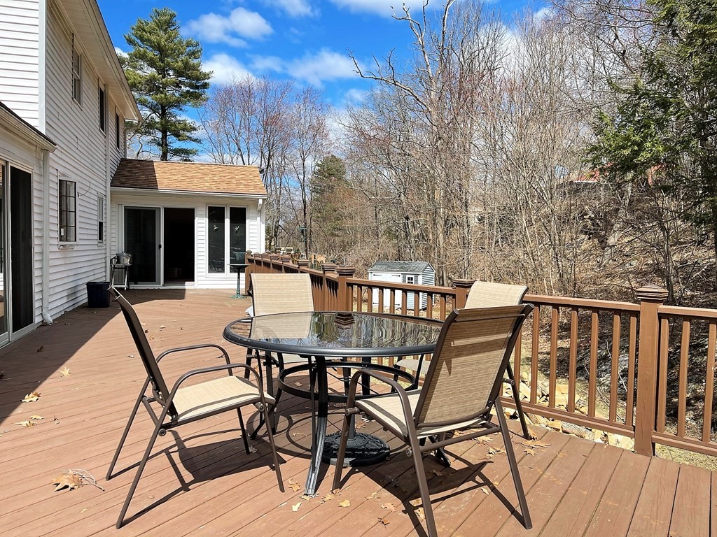 15 Shepard Road Sturbridge, MA 01566 - Photo 36 of 38 a view of a patio with table and chairs with wooden floor and fence
