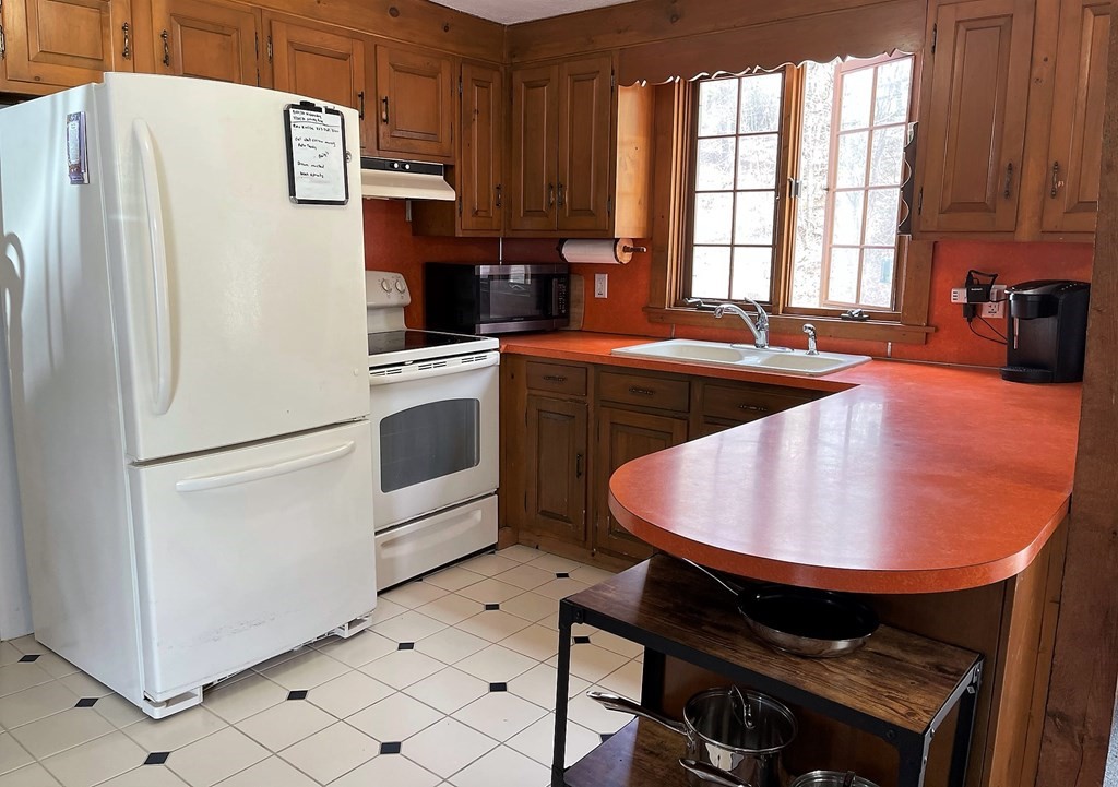 15 Shepard Road Sturbridge, MA 01566 - Photo 7 of 38 a kitchen with stainless steel appliances a refrigerator sink and cabinets