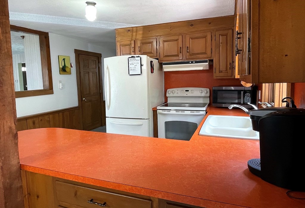 15 Shepard Road Sturbridge, MA 01566 - Photo 8 of 38 a kitchen with kitchen island a stove and a refrigerator