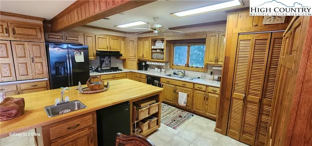 a bathroom with a sink double vanity granite and a large mirror
