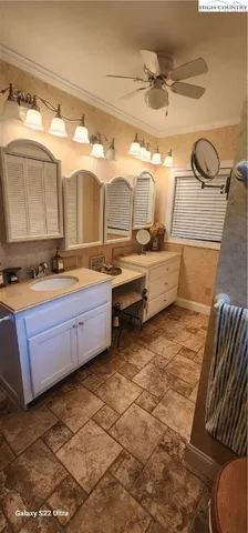 a bathroom with a sink mirror and tub