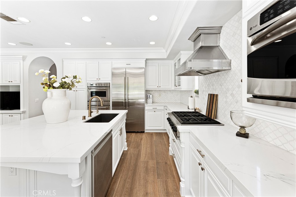 54 Valley Terrace Irvine, CA 92603 - Photo 27 of 60 a kitchen with stainless steel appliances granite countertop a sink a stove and a refrigerator