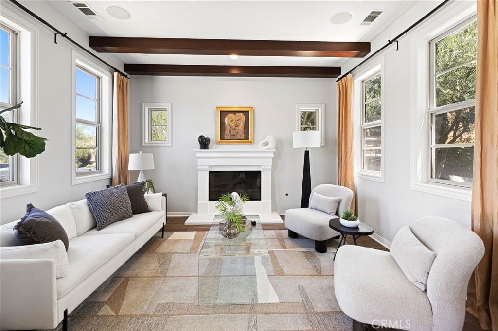 54 Valley Terrace Irvine, CA 92603 - Photo 8 of 60 a living room with furniture and a fireplace