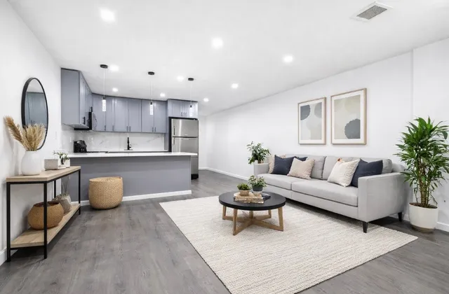 a living room with furniture and a wooden floor