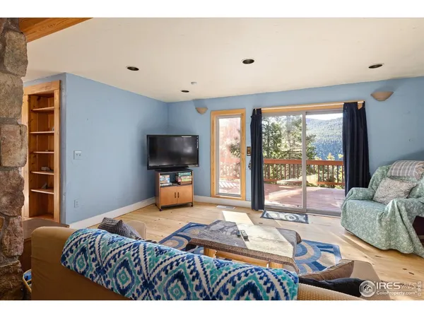 a bedroom with furniture and a flat screen tv