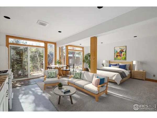 a bedroom with furniture and large windows