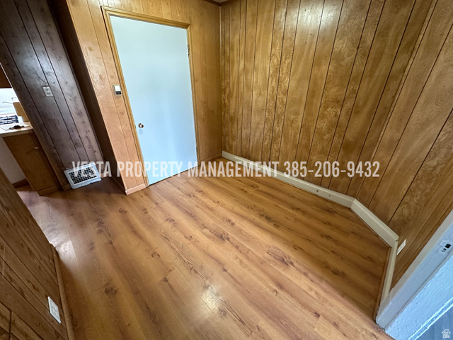 471 East 22nd Street Ogden, UT 84401 - Photo 10 of 12 Unfurnished room featuring wood finished floors and wood walls