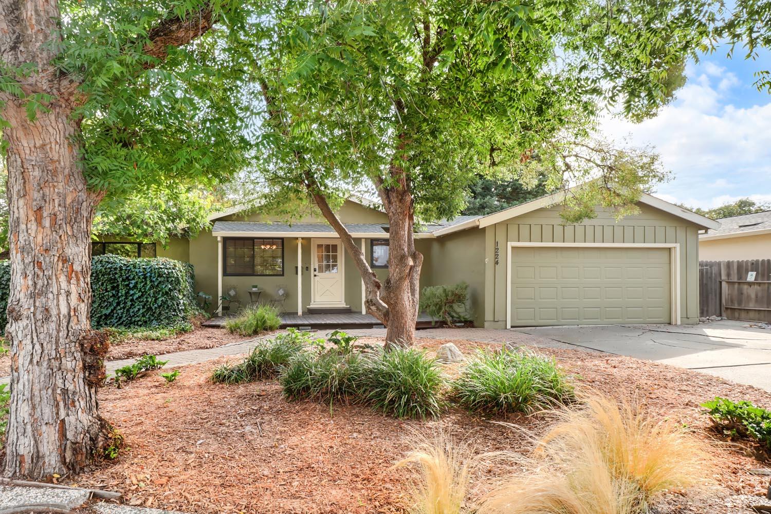1224 Spruce Lane Davis, CA 95616 - Photo 1 of 49 a front view of a house with a yard and pathway