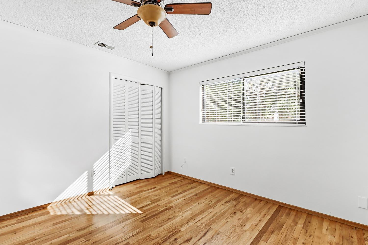 1224 Spruce Lane Davis, CA 95616 - Photo 28 of 49 a view of a livingroom with wooden floor and a ceiling fan