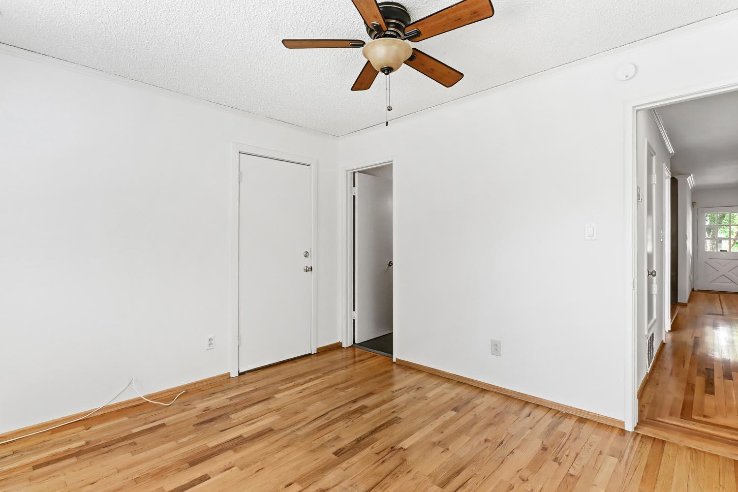 1224 Spruce Lane Davis, CA 95616 - Photo 29 of 49 a view of a room with wooden floor and a ceiling fan