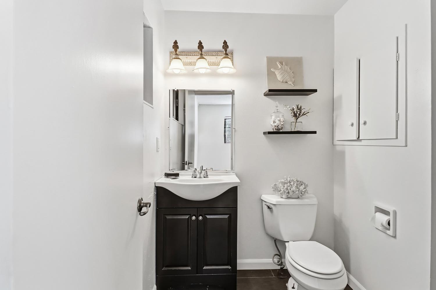1224 Spruce Lane Davis, CA 95616 - Photo 30 of 49 a bathroom with a toilet sink and mirror
