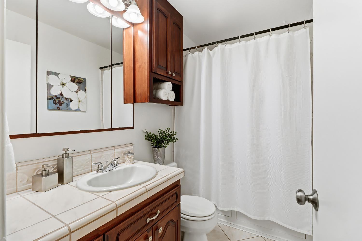 1224 Spruce Lane Davis, CA 95616 - Photo 34 of 49 a bathroom with a granite countertop sink and a mirror
