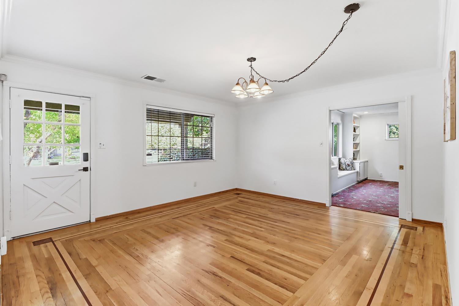 1224 Spruce Lane Davis, CA 95616 - Photo 6 of 49 a view of an empty room with wooden floor and a window