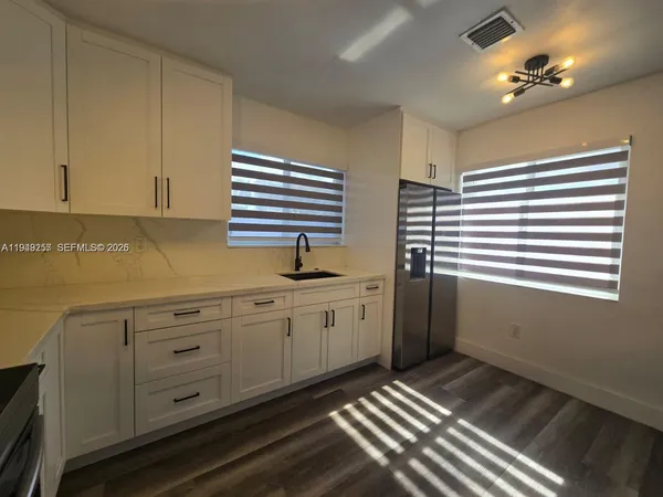a kitchen that has a sink and cabinets