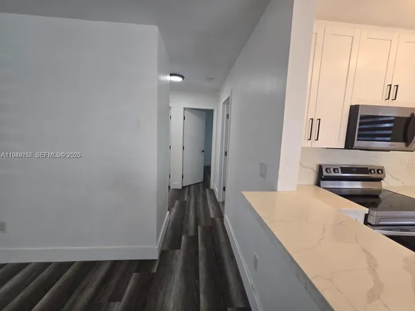 a kitchen with wooden cabinets and a stove top oven