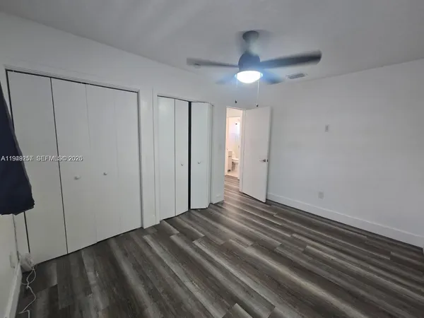a view of an empty room with a ceiling fan