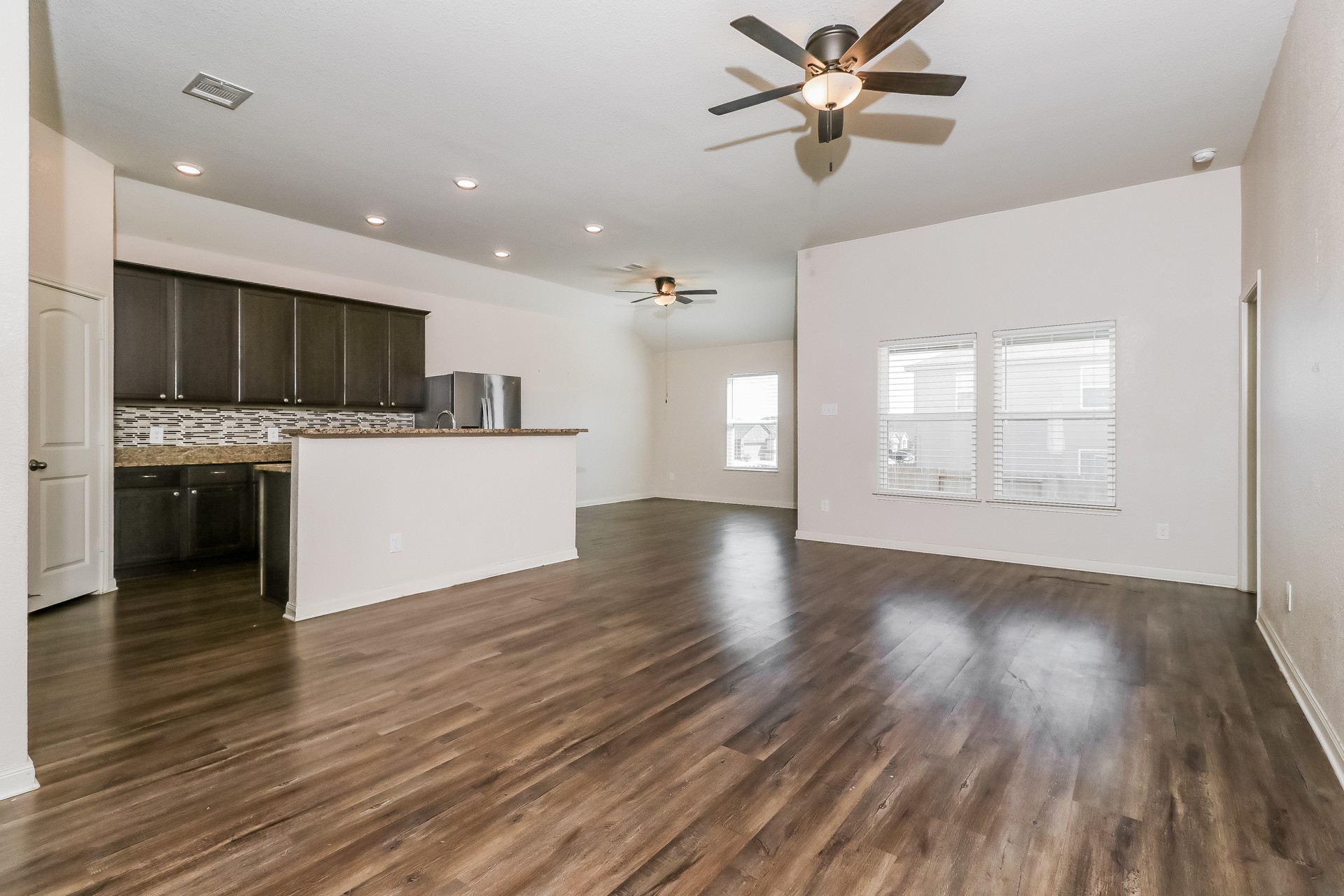 20017 Hubert R Humphrey Road Manor, TX 78653 - Photo 2 of 27 An open concept living area transitions effortlessly into a contemporary kitchen, ideal for entertaining.