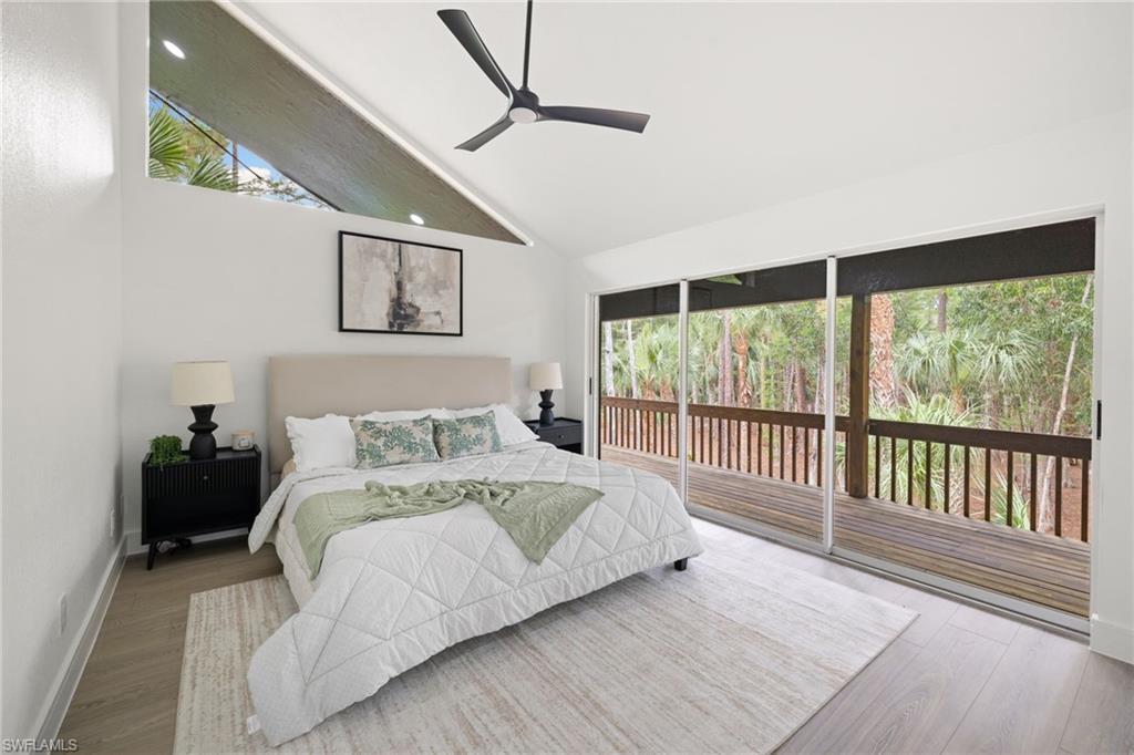 4521 3rd Avenue Northwest Naples, FL 34119 - Photo 35 of 46 a bedroom with a large bed and a large window