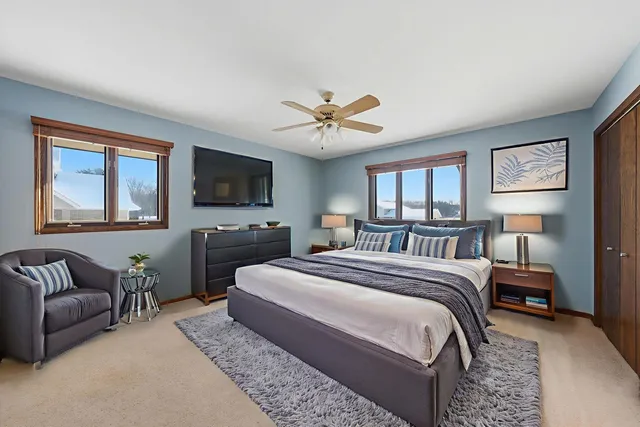 a bedroom with a large bed couch and a window