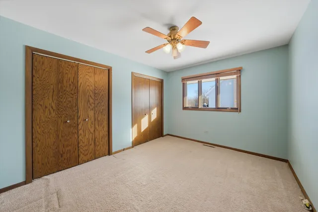a view of a big room with wooden floor and windows