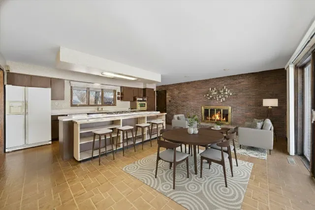 a dining room with furniture and a kitchen view