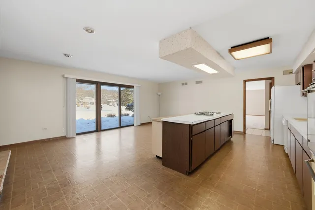 a large white kitchen with a large window