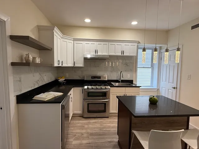 a kitchen with a stove a sink and a refrigerator
