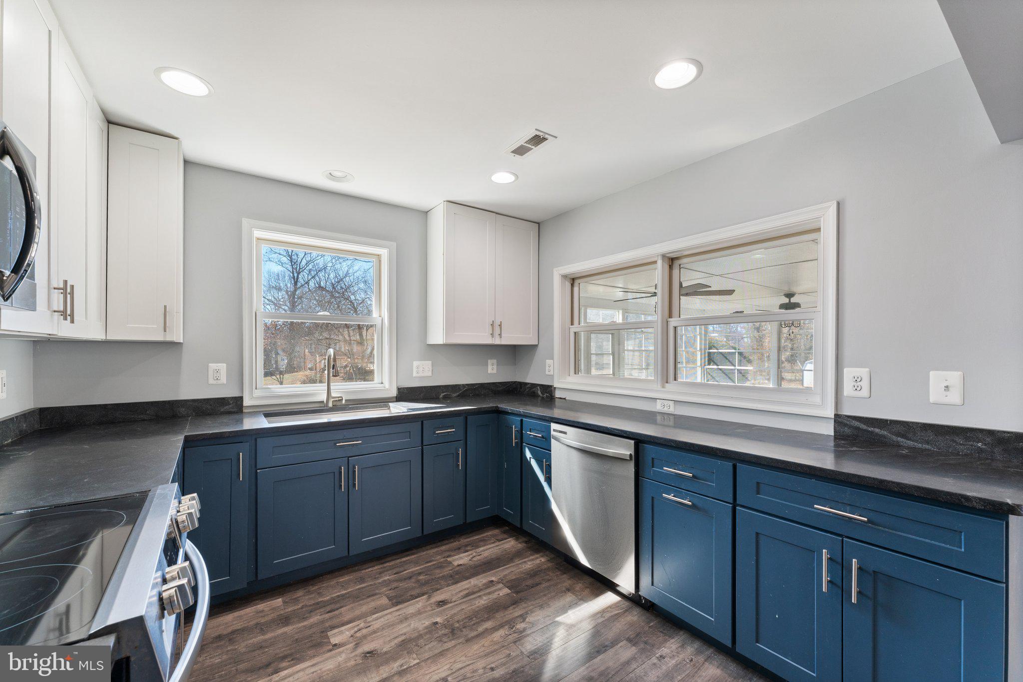 15307 Thoroughfare Road Gainesville, VA 20155 - Photo 11 of 38 a kitchen with sink and wooden cabinets