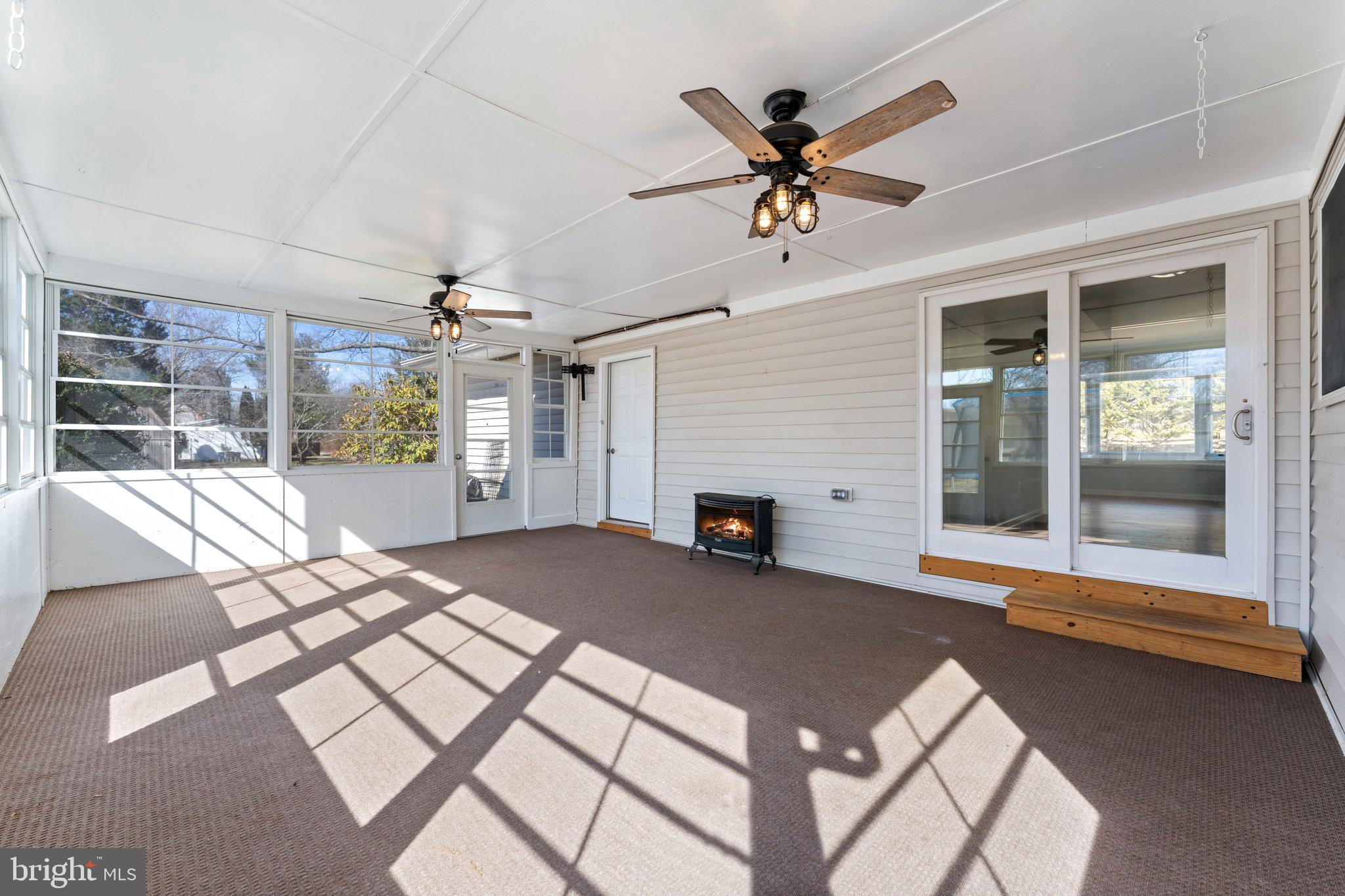 15307 Thoroughfare Road Gainesville, VA 20155 - Photo 15 of 38 a view of a livingroom with a dinning area hardwood floor a ceiling fan and windows