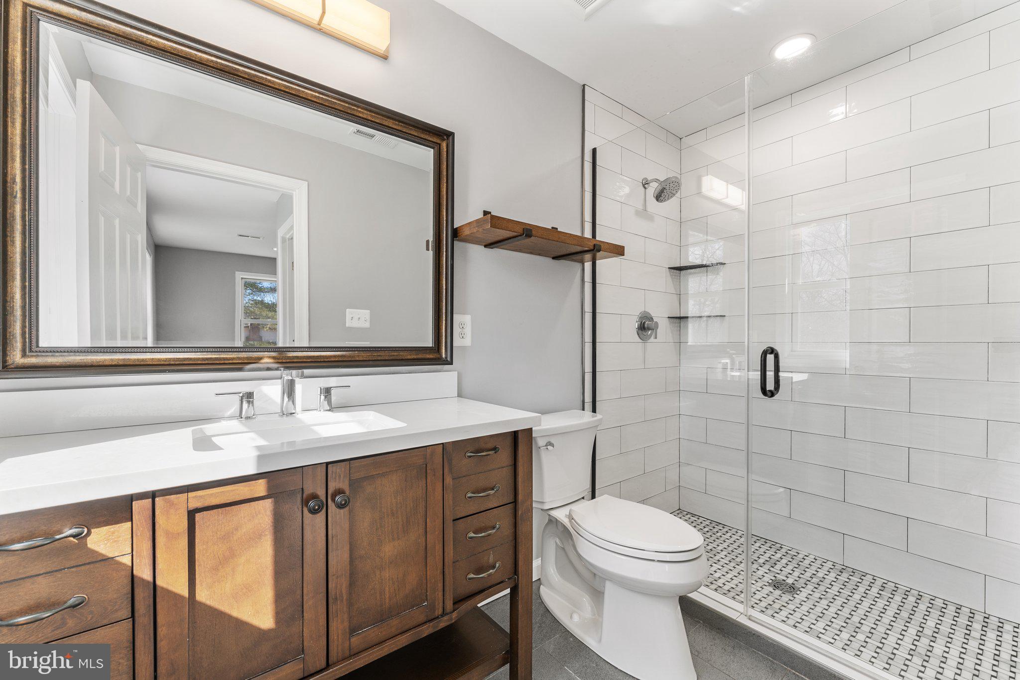 15307 Thoroughfare Road Gainesville, VA 20155 - Photo 20 of 38 a bathroom with a sink a toilet and shower
