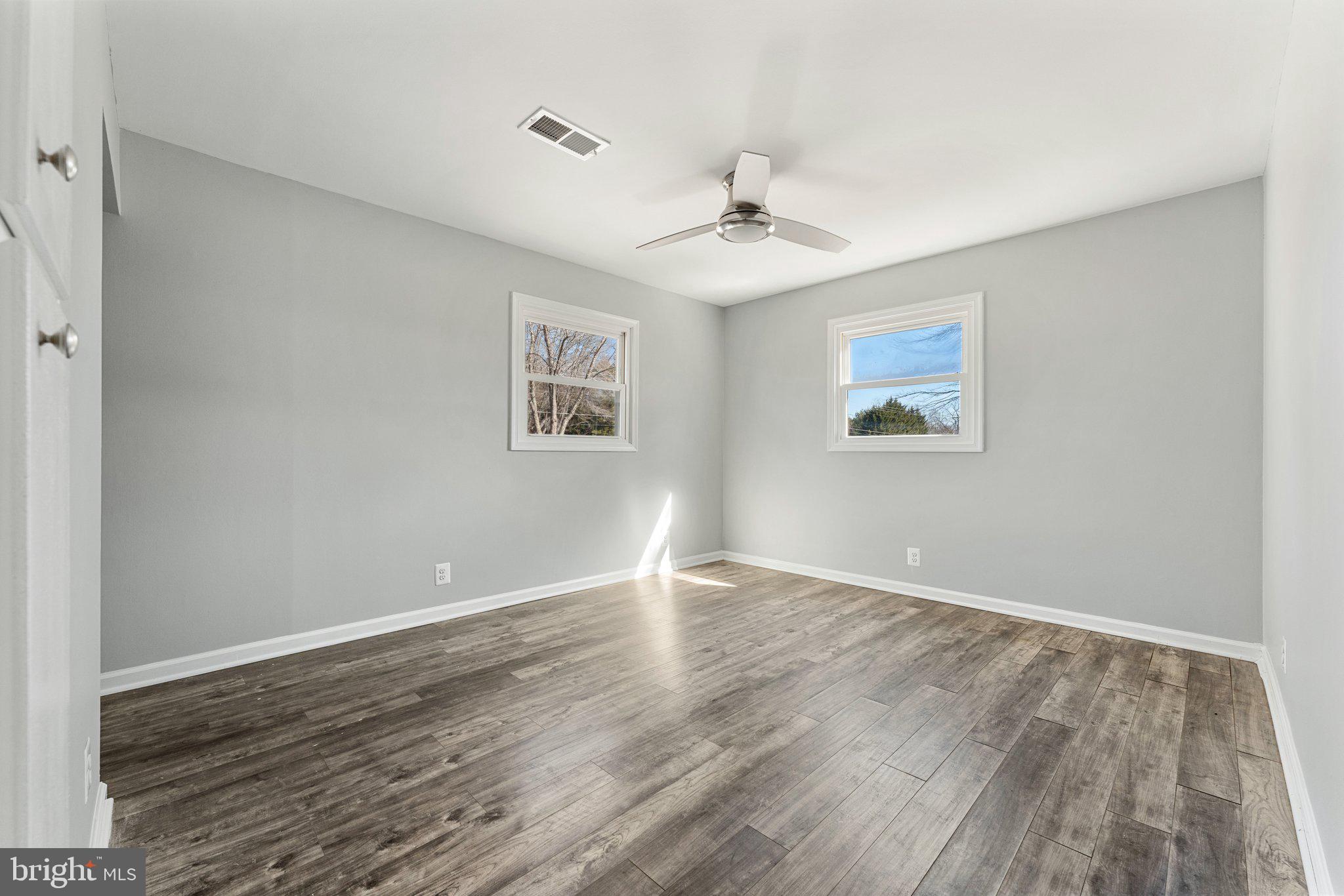 15307 Thoroughfare Road Gainesville, VA 20155 - Photo 23 of 38 a view of an empty room with wooden floor and a ceiling fan
