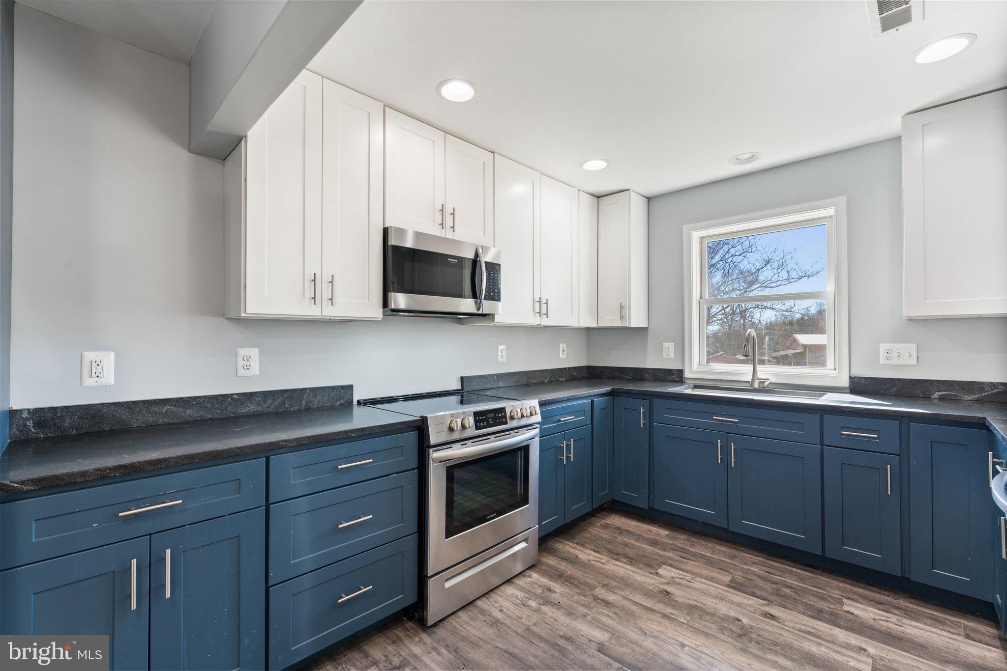 15307 Thoroughfare Road Gainesville, VA 20155 - Photo 9 of 38 a kitchen with stainless steel appliances granite countertop a stove a sink and a microwave