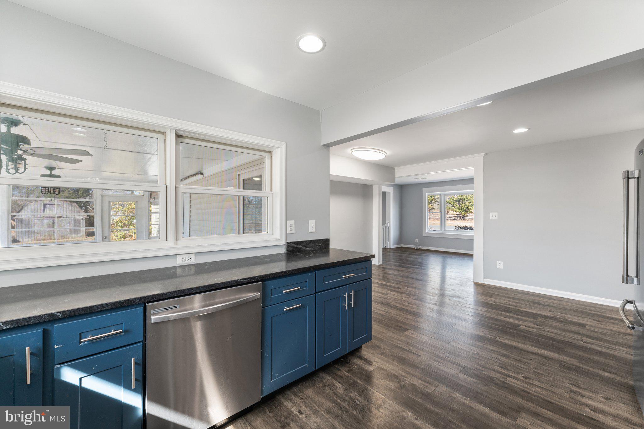 15307 Thoroughfare Road Gainesville, VA 20155 - Photo 10 of 38 a kitchen with stainless steel appliances granite countertop a sink and wooden floor