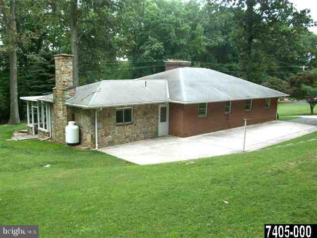 1228 Glatco Lodge Road Hanover, PA 17331 - Photo 3 of 13 a white house with a small yard and large trees