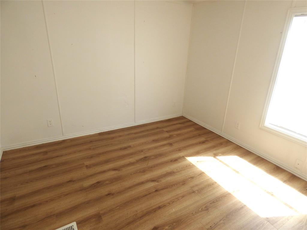 105 East 9th Street Cisco, TX 76437 - Photo 28 of 33 a view of empty room with wooden floor