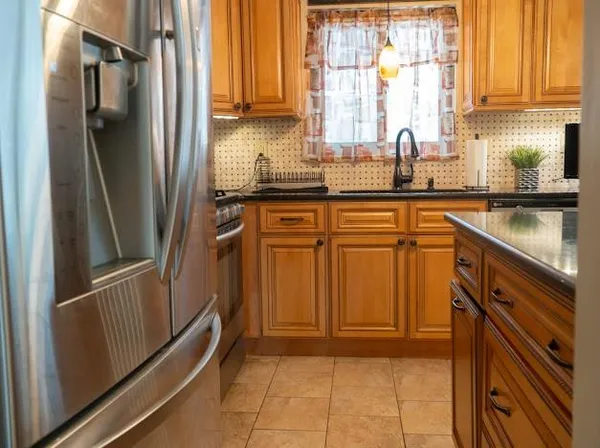 a kitchen with sink cabinets and wooden floor