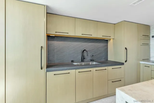 a kitchen with stainless steel appliances cabinets and wooden floor