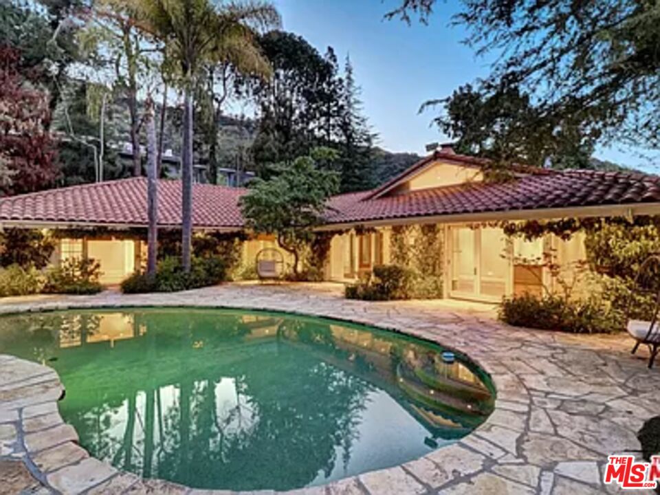 1681 Stone Canyon Road Los Angeles, CA 90077 - Photo 11 of 41 a view of a swimming pool with a patio