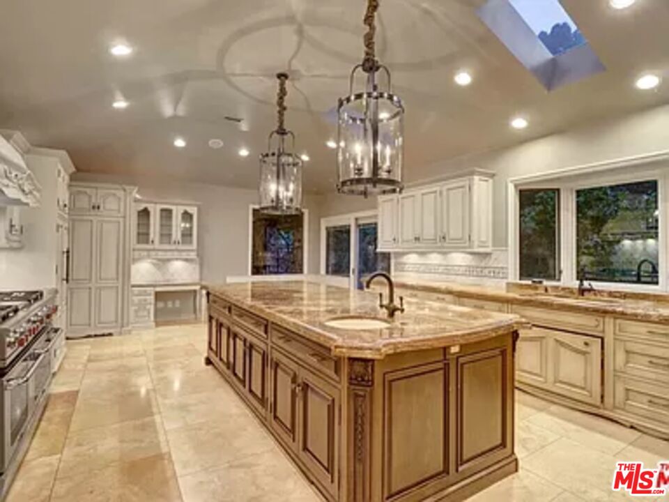 1681 Stone Canyon Road Los Angeles, CA 90077 - Photo 14 of 41 a kitchen with stainless steel appliances granite countertop a sink and cabinets